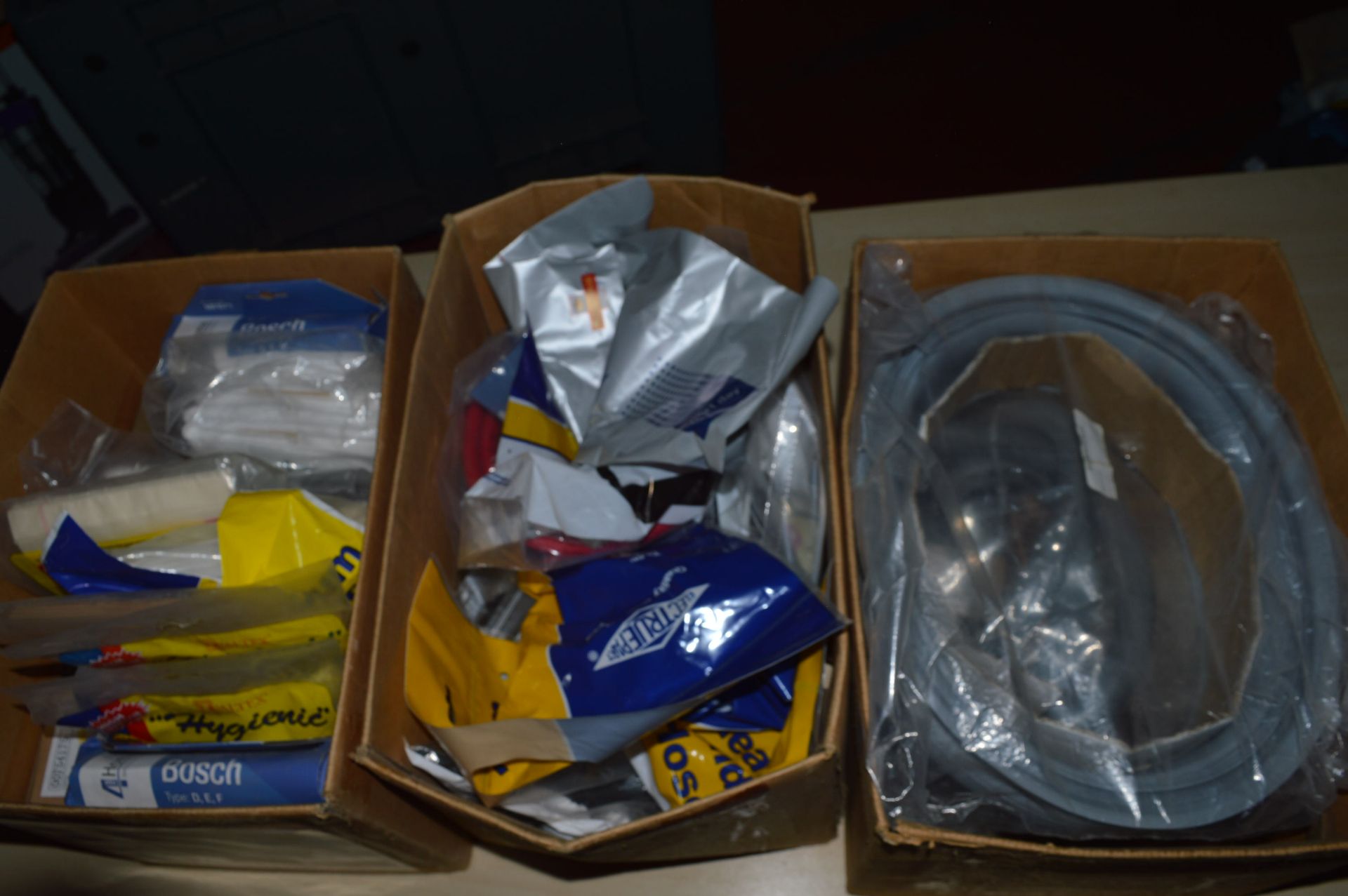 *Three Boxes of Dust Bags, Vacuum Hose Attachments, Washer Door Seal, etc.
