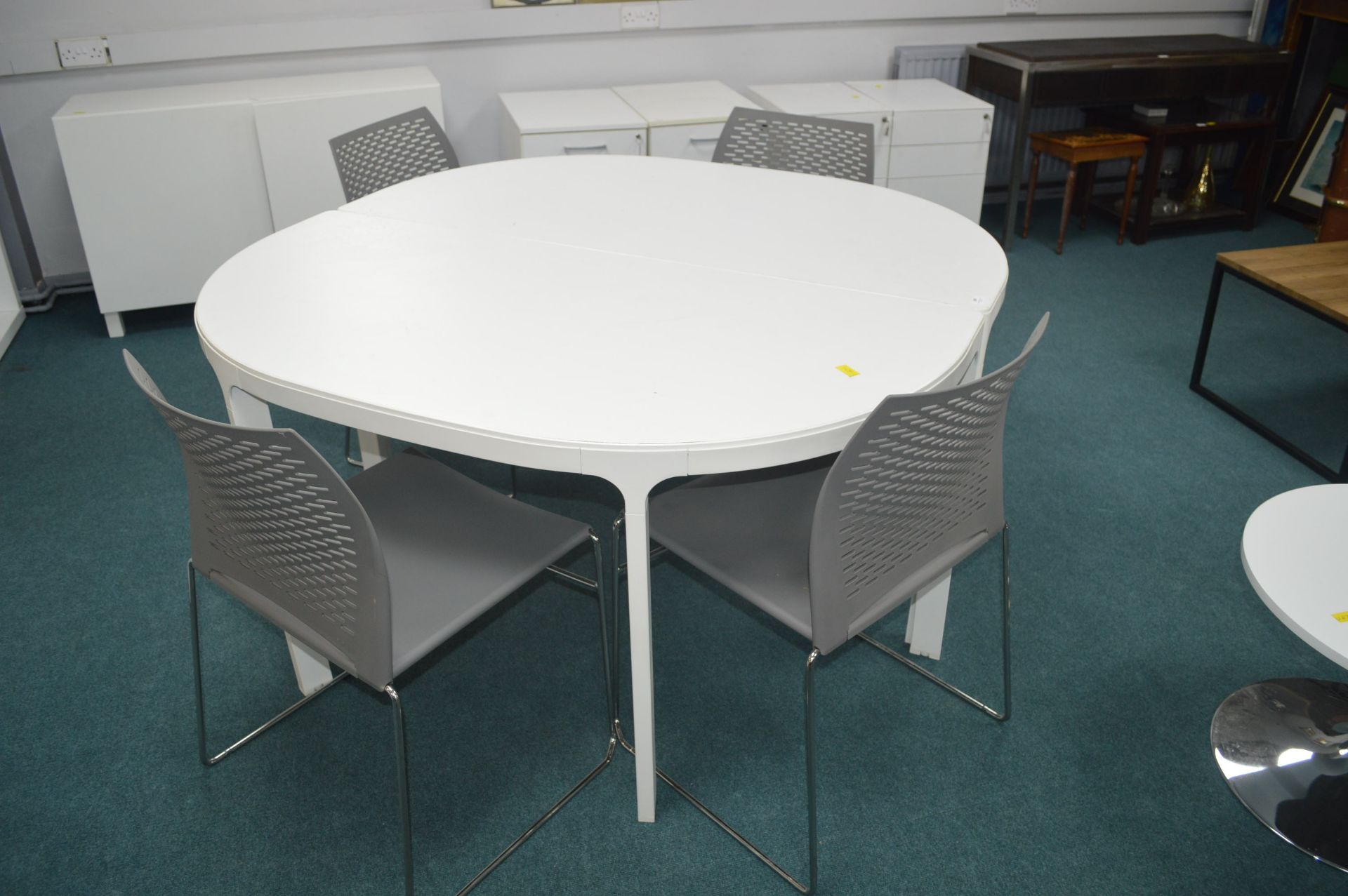 *White Circular Table and Four Grey Chairs