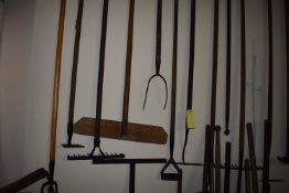 Ten Items on Wall; Rakes, Hoes, and Other Garden Tools