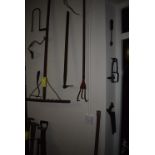 Items on Wall; Rake, Flexible Drill, Saw, Three-Prong Cultivator, etc.