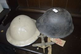 Two Military Helmets and a Brass Plane