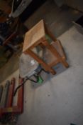 *Builder’s Wheelbarrow and a Wooden Workbench