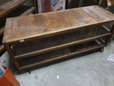 * industrial display table - on castors. (damage to bottom shelf). 1400w x 500d x 600h