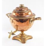 A Regency copper and brass tea urn, the reeded top and borders, on fluted handles, with brass tap,