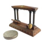 A Victorian oak and brass table gong, of four Corinthian column temple form, on a rectangular base