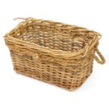 A wicker log basket, twisted rope bound with carrying handles, 38cm high, 72cm wide, 54cm deep.
