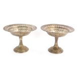A pair of George V silver pedestal sweetmeat dishes, the out flared top with pierced outer rim,