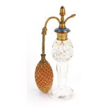 An early 20thC cut glass and enamel perfume bottle, the gilt top with blue enamel detailing on a