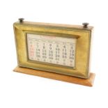 An early 20thC perpetual desk calendar, the rectangular top with paper inset, month dials and