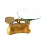 A set of W & T Avery Limited Birmingham grocer's scales, in a gilt finish with enamel bowl, to weigh