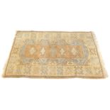 A Caucasian carpet, on a cream ground on an outer medallion border, and central large medallion,