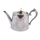 A Victorian silver plated teapot, with engraved foliate decoration, scroll handle, and an ivory