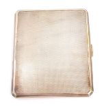 A George V silver cigarette case, rectangular with engine turned detailing and canted corners,