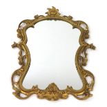 A Victorian gilt gesso rococo style wall mirror, with foliate carving, 76cm high, 61cm wide.