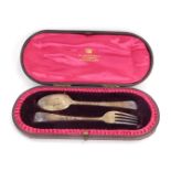 An Edward VII silver presentation knife and spoon set, retailed by W Greenwell Silversmiths of