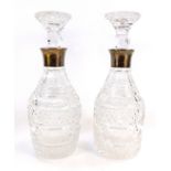 A pair of cut glass and silver mounted decanters, of mallet form, London 1961, 29cm high.