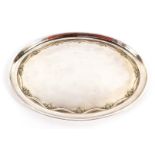 A George V silver oval tray, with embossed Neo Classical floral and drape decoration, Birmingham