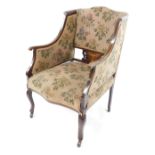 A Victorian mahogany and inlaid armchair, with over stuffed floral upholstery, raised on cabriole