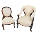 A Victorian mahogany nursing chair, upholstered in cream and white over stuffed upholstery, raised
