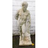 A cast concrete figure of Zeus, carrying a cloak, perched against a rock, 60cm high.