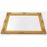 A Victorian style gilt framed rectangular wall mirror, with floral scroll capped detailing and