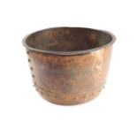 A hammered copper log bucket, with studded strap work, 30cm high, 50cm diameter.