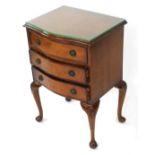 A Georgian style burr walnut serpentine bedside chest, of three graduated drawers, raised on shell