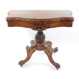 A Victorian walnut serpentine fold over card table, with carved foliate and scroll detailing,