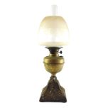 A Duplex brass and cast oil lamp, with an Art Nouveau floral base, brass reservoir, glass chimney,