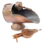 A Victorian copper coal helmet shaped scuttle, with scoop and fire bellows.