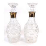 A pair of cut glass and silver mounted decanters, of mallet form, London 1961, 29cm high.