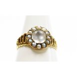 A Victorian moonstone dress ring, the circular central panel set with a large moonstone surrounded