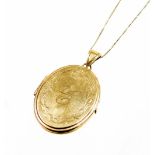 A 9ct gold locket and chain, the circular locket of plain outer design but bearing the initial C