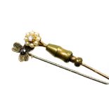 Two stick pins, a diamond and seed pearl cluster pin, yellow metal stamped 15ct, and a silver pin in