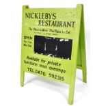 A green and black painted advertising A-board sign for Nickleby's Restaurant, St Peter's Place,