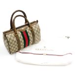 A vintage Gucci Ophidia canvas bowling bag, with brown leather trim and handles, the interior with a