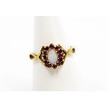 A 9ct gold dress ring, central cluster set with opal and garnet on twist shoulders, ring size N, 1.