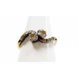 An 18ct gold and platinum diamond twist ring, set with two old cut diamonds in claw setting, with