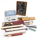 Drawing related items, to include a slate, slide rule, a Clive's mathematical instruments, box,