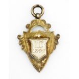 A silver gilt shield fob, central shield bearing initials L.C 1892, 9.5g.