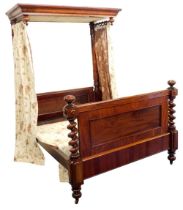 A Victorian mahogany half tester bed, the mahogany canopy with drop turned finals supported with
