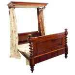 A Victorian mahogany half tester bed, the mahogany canopy with drop turned finals supported with