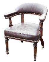 A 19thC mahogany and gilt metal library chair, upholstered in studded brown leather with turned