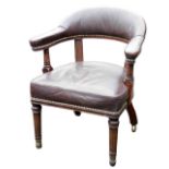 A 19thC mahogany and gilt metal library chair, upholstered in studded brown leather with turned