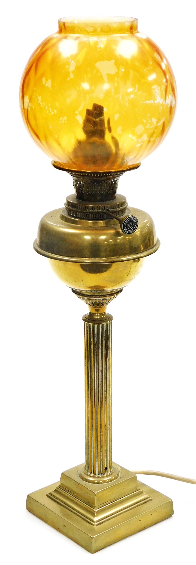 A Young's brass oil lamp, converted to electricity, of fluted column form, raised on a stepped