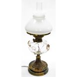 A Victorian oil lamp, with a frosted shade, clear and pink blown glass central reservoir, on a brass