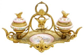 A 19thC French porcelain and ormolu mounted desk stand, possibly Sevres, the central dish painted