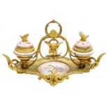 A 19thC French porcelain and ormolu mounted desk stand, possibly Sevres, the central dish painted