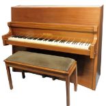 A mahogany upright piano by Bentley, with concave front and shaped sizes.