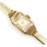 A lady's wristwatch, with 9ct gold square set wristwatch head, on a plated strap, 10.7g all in.